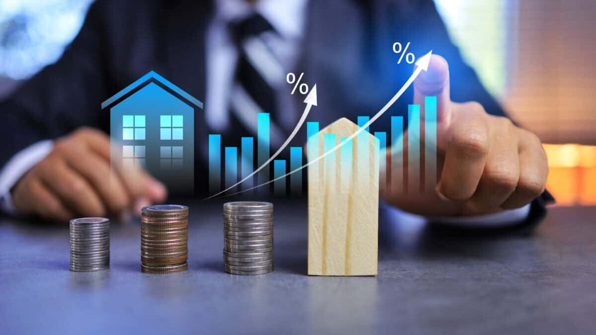 Real estate investment concept with person pointing on growth graph and coin stacking to get profit from property
