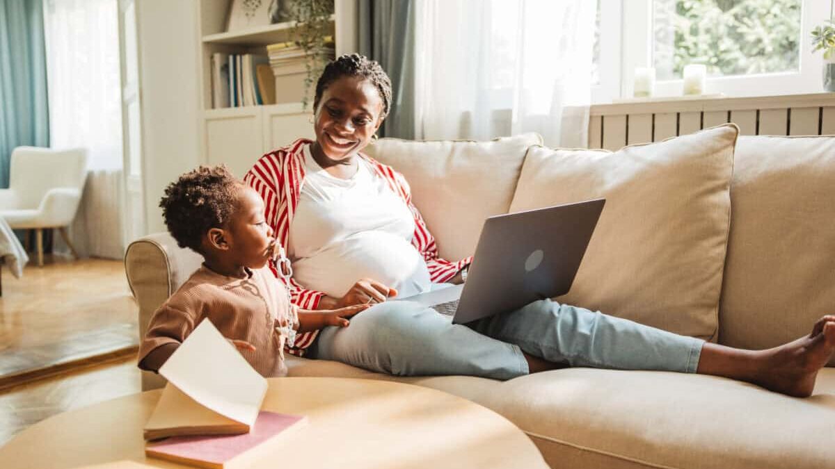pregnant mother juggles work and childcare
