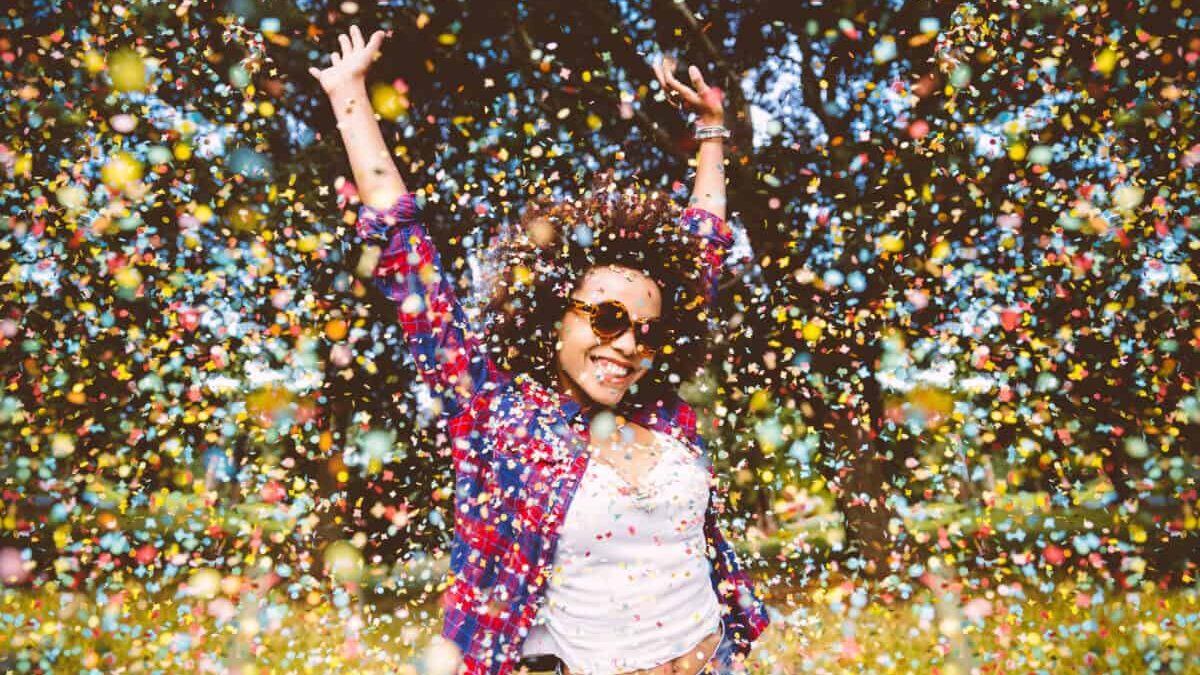 person enjoys shower of confetti outside